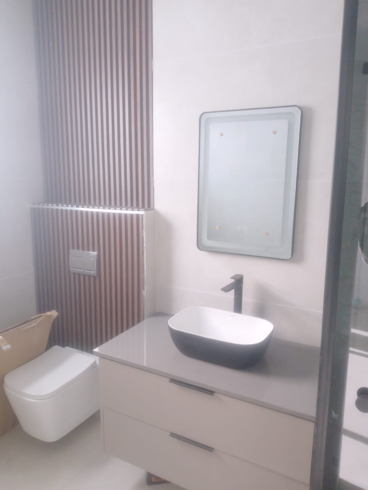 Modern guest bathroom with vanity and LED mirror